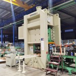 The combined leveler, feeder, and punch press unit of a cable tray line. The leveler flattens the metal strip, the feeder accurately positions it, and the multi-tool punch press creates ventilation holes and mounting slots.