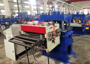 The servo feeder guiding the metal strip into a large hydraulic or mechanical punching press, which is used to pre-punch necessary holes or slots.