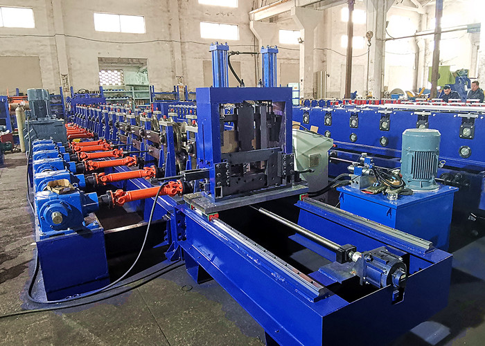 A panoramic shot showing the entire C/Z purlin production line, from the uncoiler on the left to the final cutting device and run-out table on the right, in a factory setting.