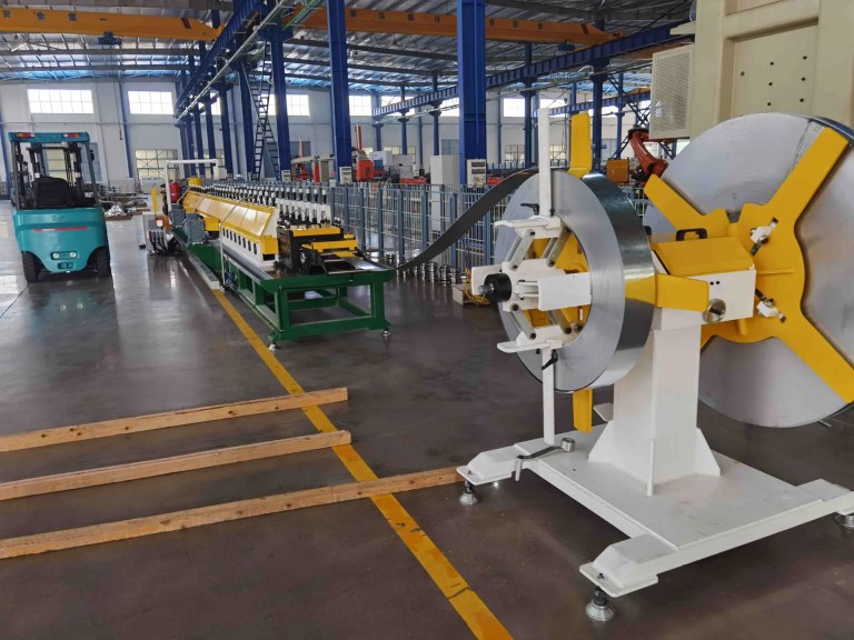 Double header uncoiler supplying material to a medium speed strut channel roll forming machine.