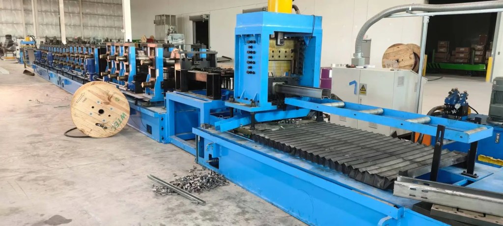 Flying hydraulic cutter in action on a sigma purlin roll forming machine, making a clean cut.