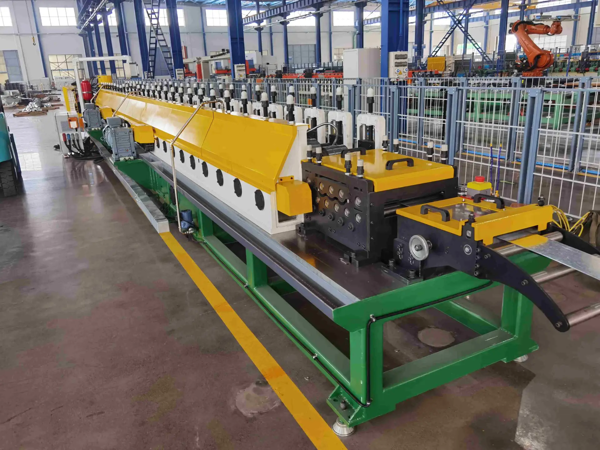 Precision roll former feeder guiding steel into a medium speed strut channel roll forming machine.