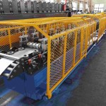 Long line of roll forming stands gradually shaping a metal strip into a door frame